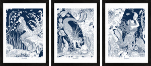 Set of three detailed navy blue framed art prints of mermaids underwater.