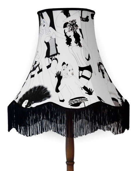 Floor lamp with a black and white patterned shade on a white background