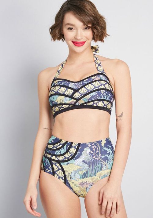 Woman wearing a colorful bikini with a gray background